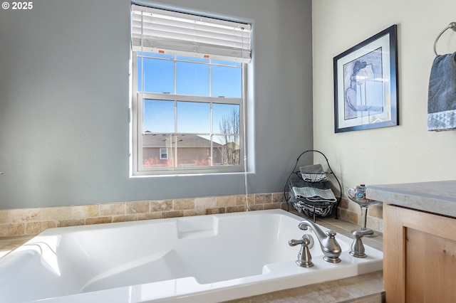 bathroom with a relaxing tiled tub and vanity