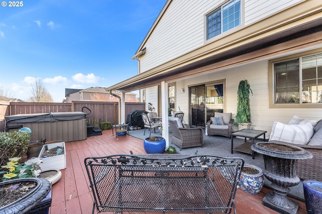 deck featuring an outdoor living space and a hot tub