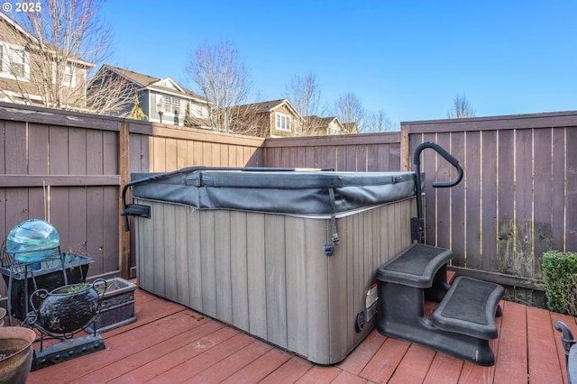 wooden deck featuring a hot tub