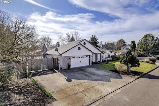 view of front facade featuring a front lawn, fence, concrete driveway, a garage, and brick siding