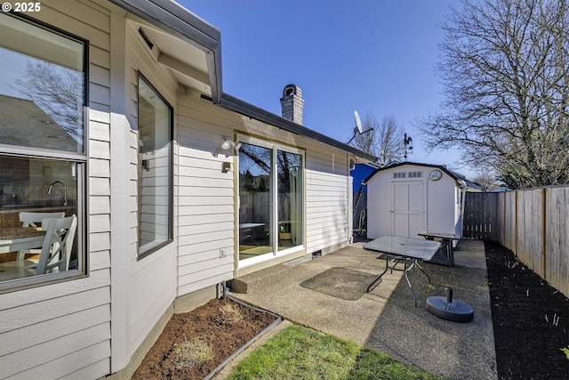 view of patio with a storage shed, a fenced backyard, and an outdoor structure