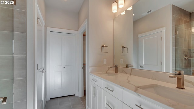 bathroom with tile patterned flooring, vanity, and a shower with shower door