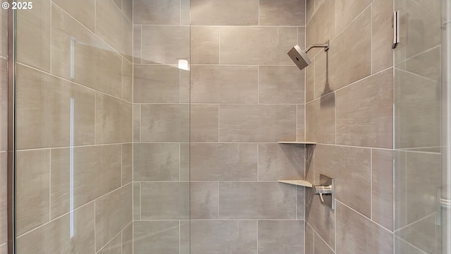 interior details featuring tiled shower