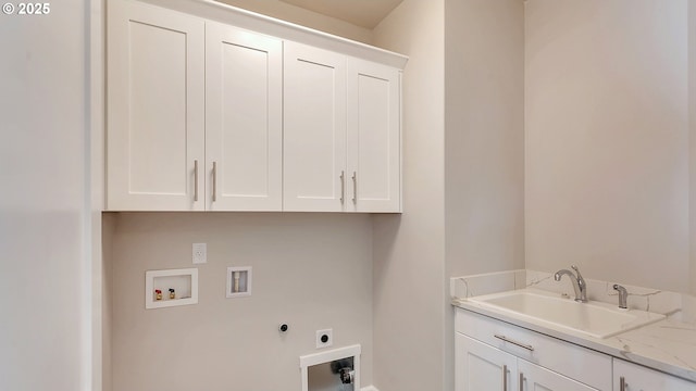 clothes washing area with washer hookup, sink, cabinets, and hookup for an electric dryer