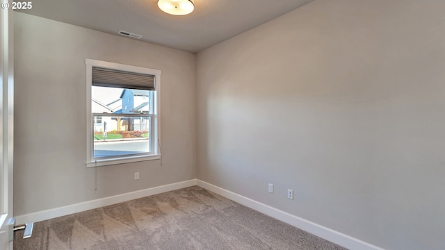 unfurnished room featuring light colored carpet