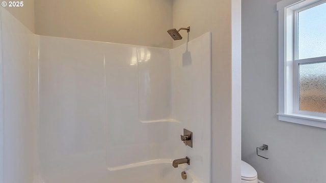 room details featuring shower / bathtub combination and toilet