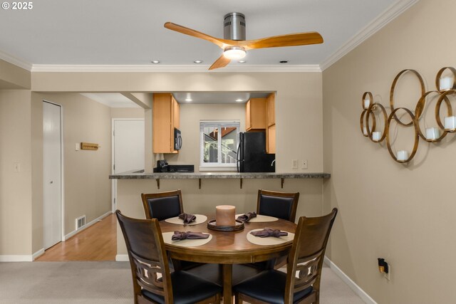5050 S Landing Dr Unit 202, Portland, OR 97239 - dining room with crown molding, baseboards, a ceiling fan, recessed lighting, and light carpet