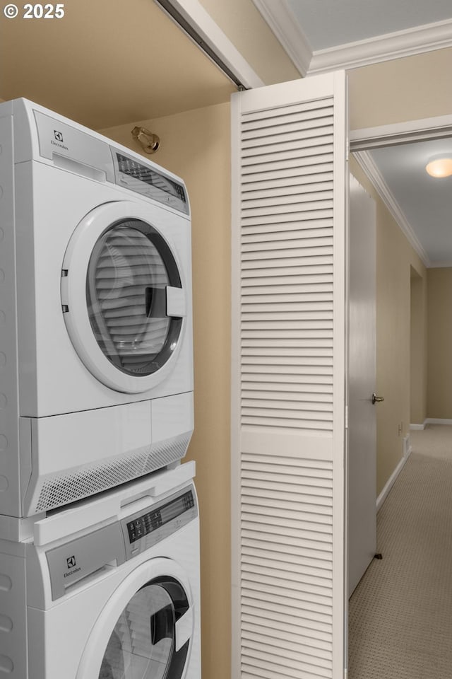 5050 S Landing Dr Unit 202, Portland, OR 97239 - laundry room with stacked washer / drying machine, ornamental molding, carpet flooring, and baseboards