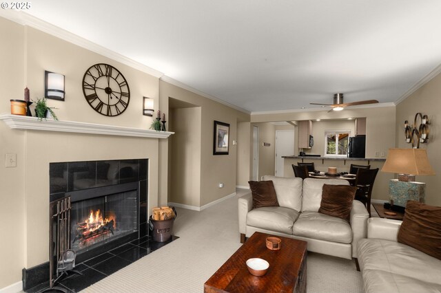 5050 S Landing Dr Unit 202, Portland, OR 97239 - living area with crown molding, ceiling fan, baseboards, a tile fireplace, and carpet flooring