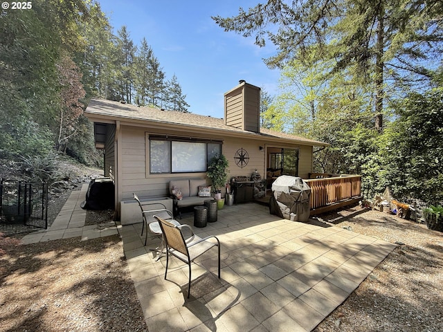 1546 Seacrest Ln, Brookings, OR 97415 - rear view of house featuring roof with shingles, a chimney, a patio area, and a deck