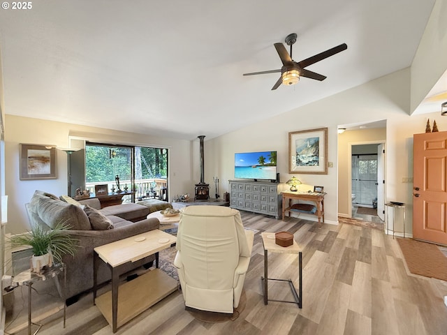 1546 Seacrest Ln, Brookings, OR 97415 - living room featuring a wood stove, light wood finished floors, a ceiling fan, and vaulted ceiling