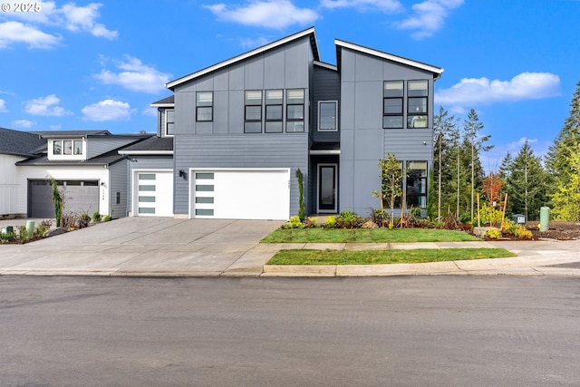 modern home featuring board and batten siding, concrete driveway, and a garage