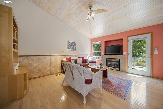 16952 SE Dunhill Loop, Damascus, OR 97089 - living room featuring lofted ceiling, wooden ceiling, a ceiling fan, a glass covered fireplace, and wood finished floors
