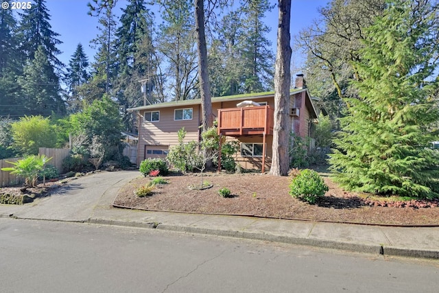 bi-level home with a garage and a deck