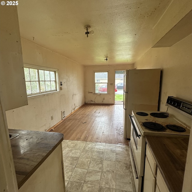 kitchen with dark countertops and white electric range oven