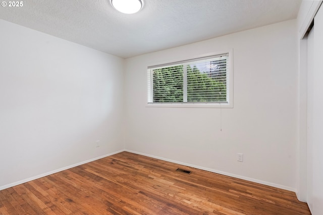 165 NE 167th Pl, Portland, OR 97230 - spare room featuring wood finished floors and a textured ceiling