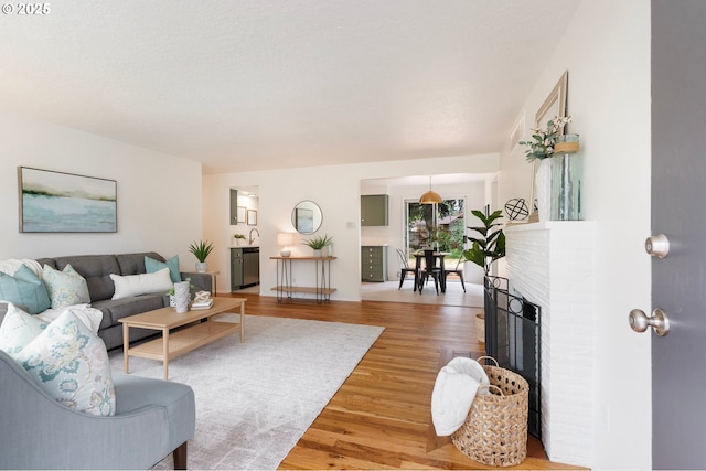 165 NE 167th Pl, Portland, OR 97230 - living room featuring light wood-style flooring and a fireplace