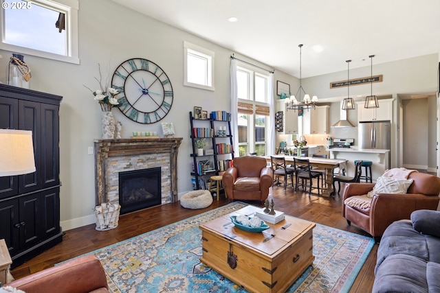 living room with a chandelier, dark wood-style floors, a fireplace, and recessed lighting