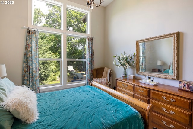 bedroom featuring multiple windows and a chandelier