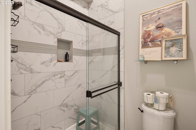bathroom with a stall shower and toilet