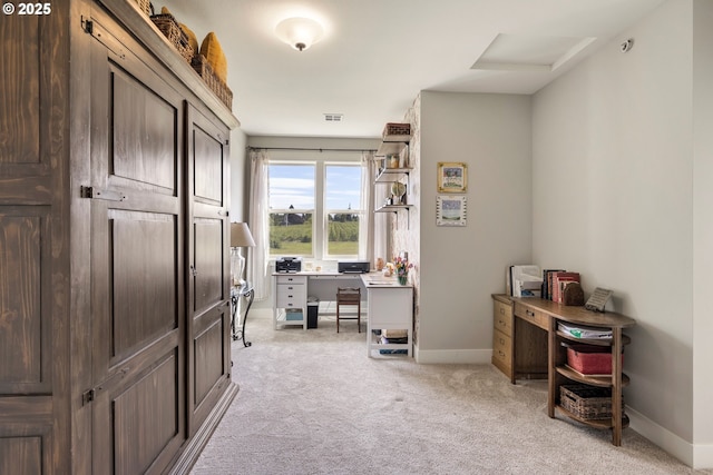 office space featuring light colored carpet and baseboards