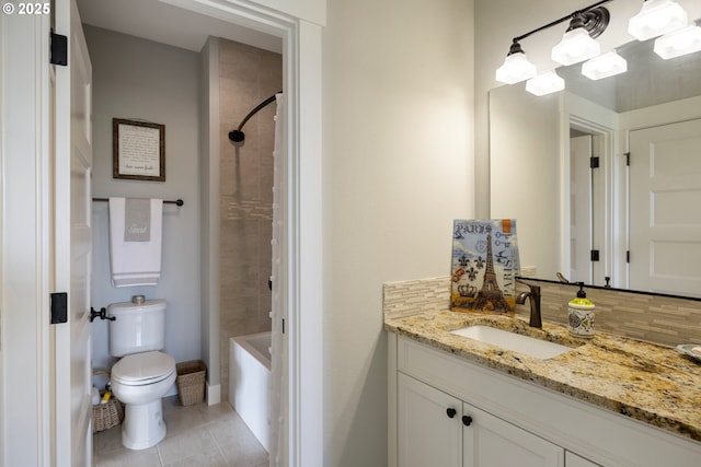 bathroom featuring toilet, tile patterned floors, vanity, decorative backsplash, and shower / bathtub combination