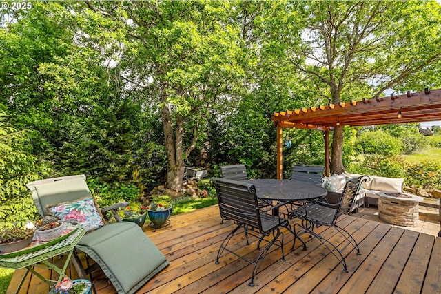 wooden deck featuring an outdoor fire pit, a pergola, and outdoor dining space