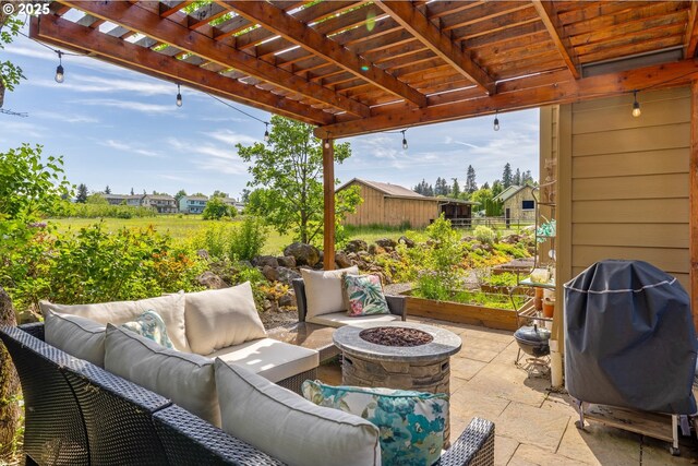 view of patio with an outdoor living space with a fire pit and a pergola