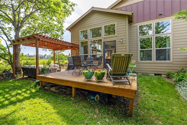 rear view of house with a pergola, a wooden deck, a lawn, and outdoor dining area