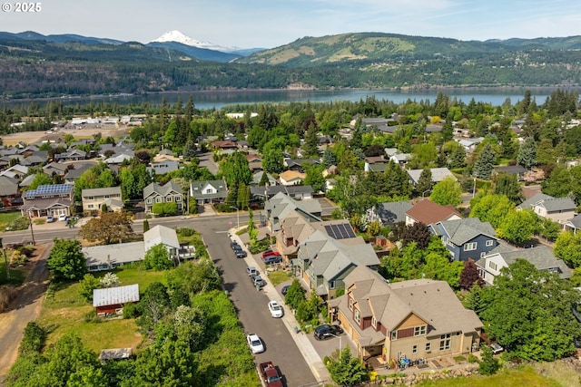 aerial view of residential area featuring a water and mountain view