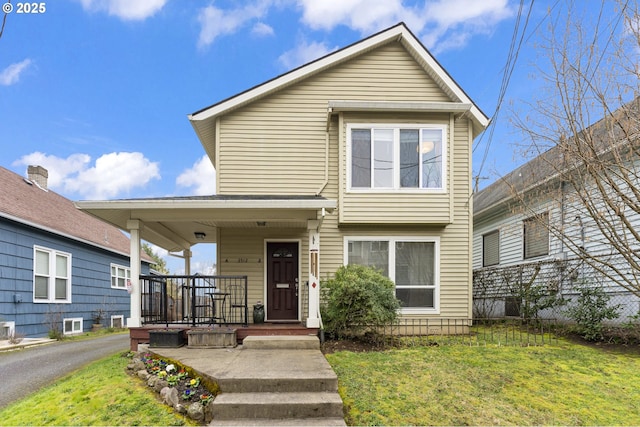 view of front of house with a porch and a front lawn