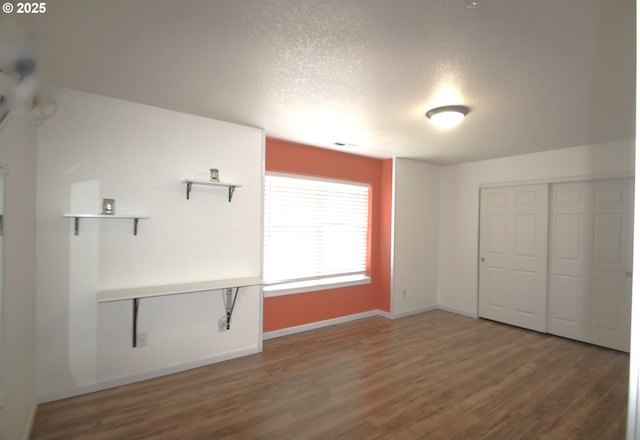 1974 N Laurelwood St, Canby, OR 97013 - unfurnished bedroom with a textured ceiling, wood finished floors, and a closet