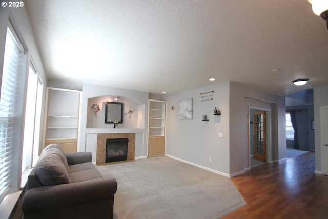 1974 N Laurelwood St, Canby, OR 97013 - living room with a textured ceiling, a fireplace, recessed lighting, built in shelves, and light carpet