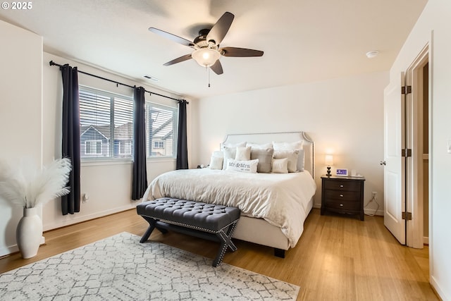 bedroom with light hardwood / wood-style floors and ceiling fan