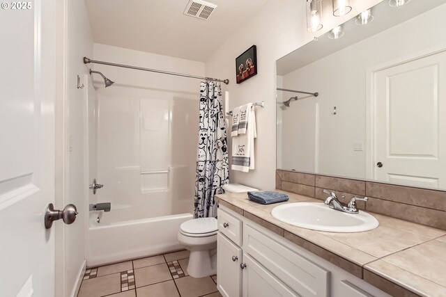 full bathroom with tile patterned floors, backsplash, toilet, shower / bath combo with shower curtain, and vanity