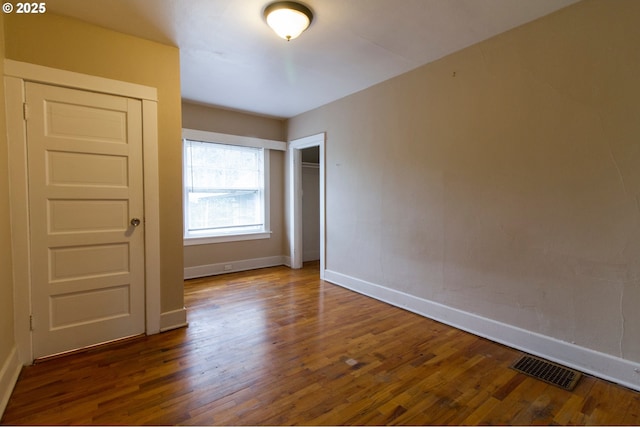 1522 N Rosa Parks Way, Portland, OR 97217 - unfurnished bedroom with a closet, wood finished floors, visible vents, and baseboards
