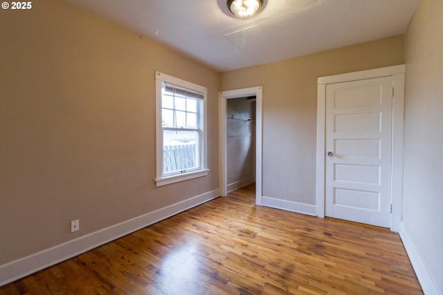 1522 N Rosa Parks Way, Portland, OR 97217 - unfurnished bedroom featuring baseboards, wood finished floors, and a closet