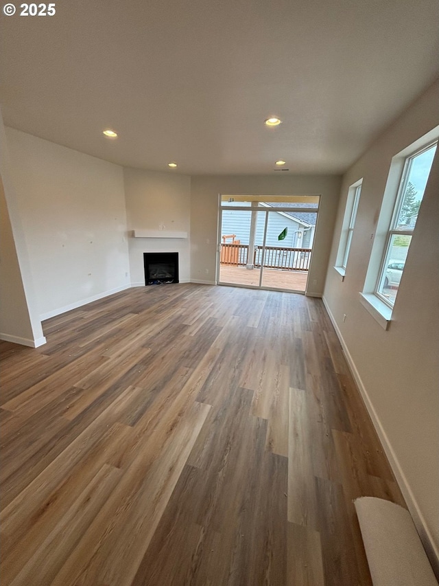 9314 Glory Ct NE, Salem, OR 97305 - unfurnished living room featuring wood finished floors, healthy amount of natural light, baseboards, and recessed lighting