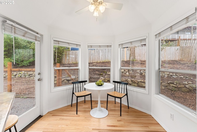 sunroom / solarium featuring ceiling fan