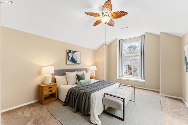 bedroom featuring visible vents, baseboards, light colored carpet, ceiling fan, and vaulted ceiling