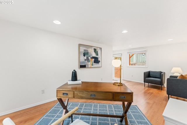 office space featuring recessed lighting, light wood-style flooring, and baseboards