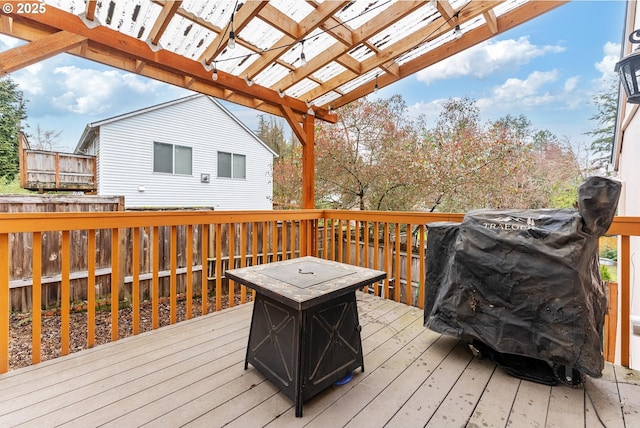 deck featuring a pergola and grilling area