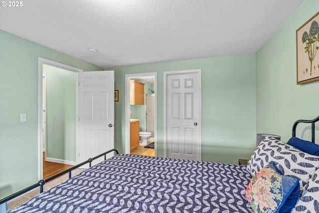 34637 E Knox Butte Rd, Albany, OR 97322 - carpeted bedroom with ensuite bathroom and a textured ceiling