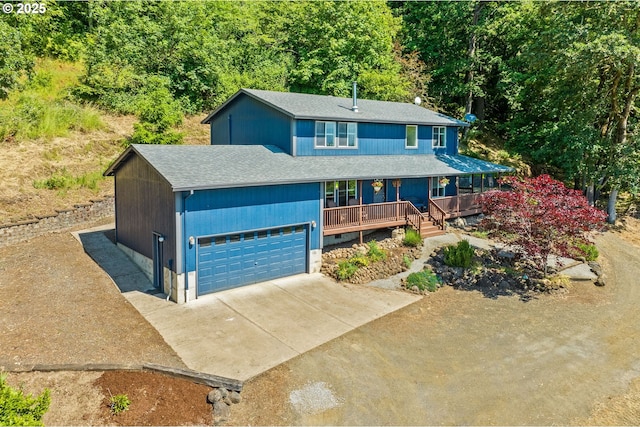 34637 E Knox Butte Rd, Albany, OR 97322 - view of front of house featuring covered porch, a garage, concrete driveway, a shingled roof, and a forest view