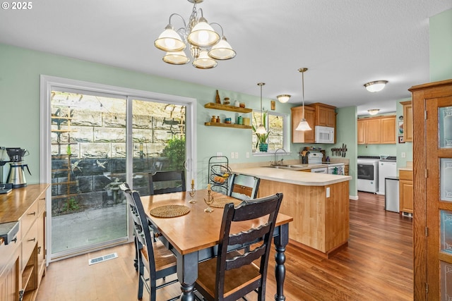 34637 E Knox Butte Rd, Albany, OR 97322 - dining space with independent washer and dryer, light wood-style floors, and a chandelier