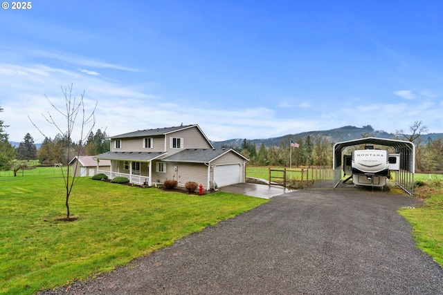 40510 NE 261st Ct, Amboy, WA 98601 - view of home's exterior featuring a detached carport, a mountain view, aphalt driveway, a porch, and a lawn