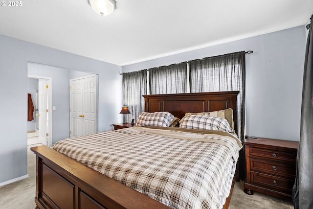 40510 NE 261st Ct, Amboy, WA 98601 - bedroom featuring a closet, ensuite bathroom, light colored carpet, and baseboards