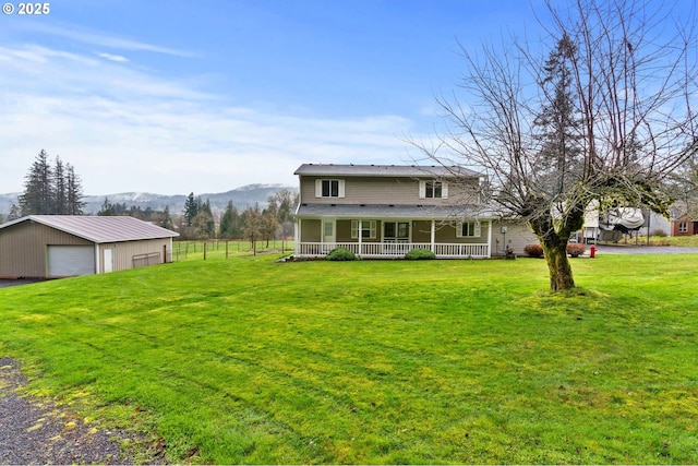 40510 NE 261st Ct, Amboy, WA 98601 - rear view of property with a mountain view, a yard, a detached garage, covered porch, and an outbuilding