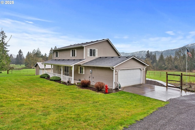 40510 NE 261st Ct, Amboy, WA 98601 - view of front facade with an attached garage, a porch, fence, concrete driveway, and a front lawn