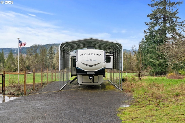40510 NE 261st Ct, Amboy, WA 98601 - view of parking / parking lot featuring a detached carport, fence, and driveway